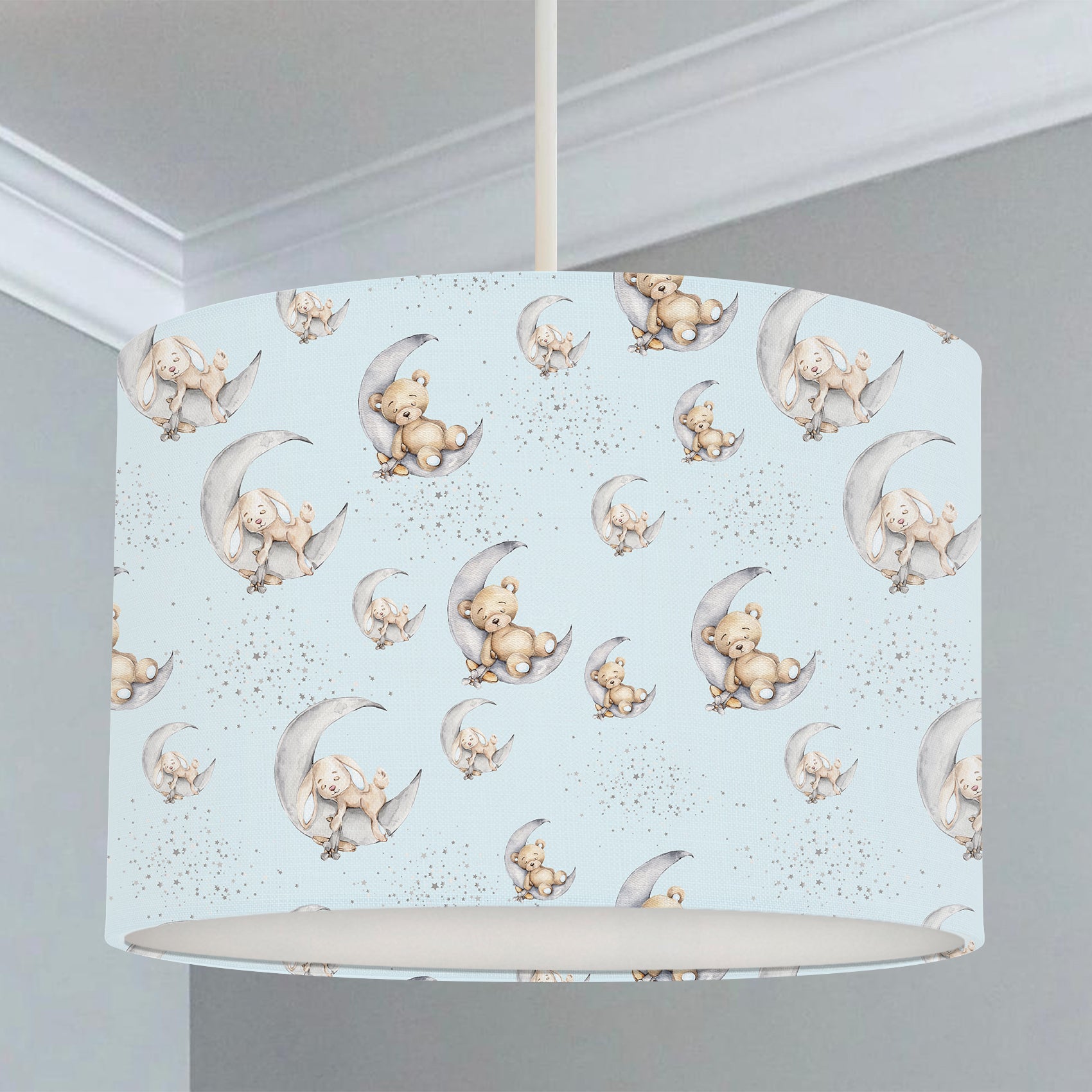 Children's bedroom and nursery lampshade featuring bunny rabbits and teddy bears sleeping on grey moons on a blue background.