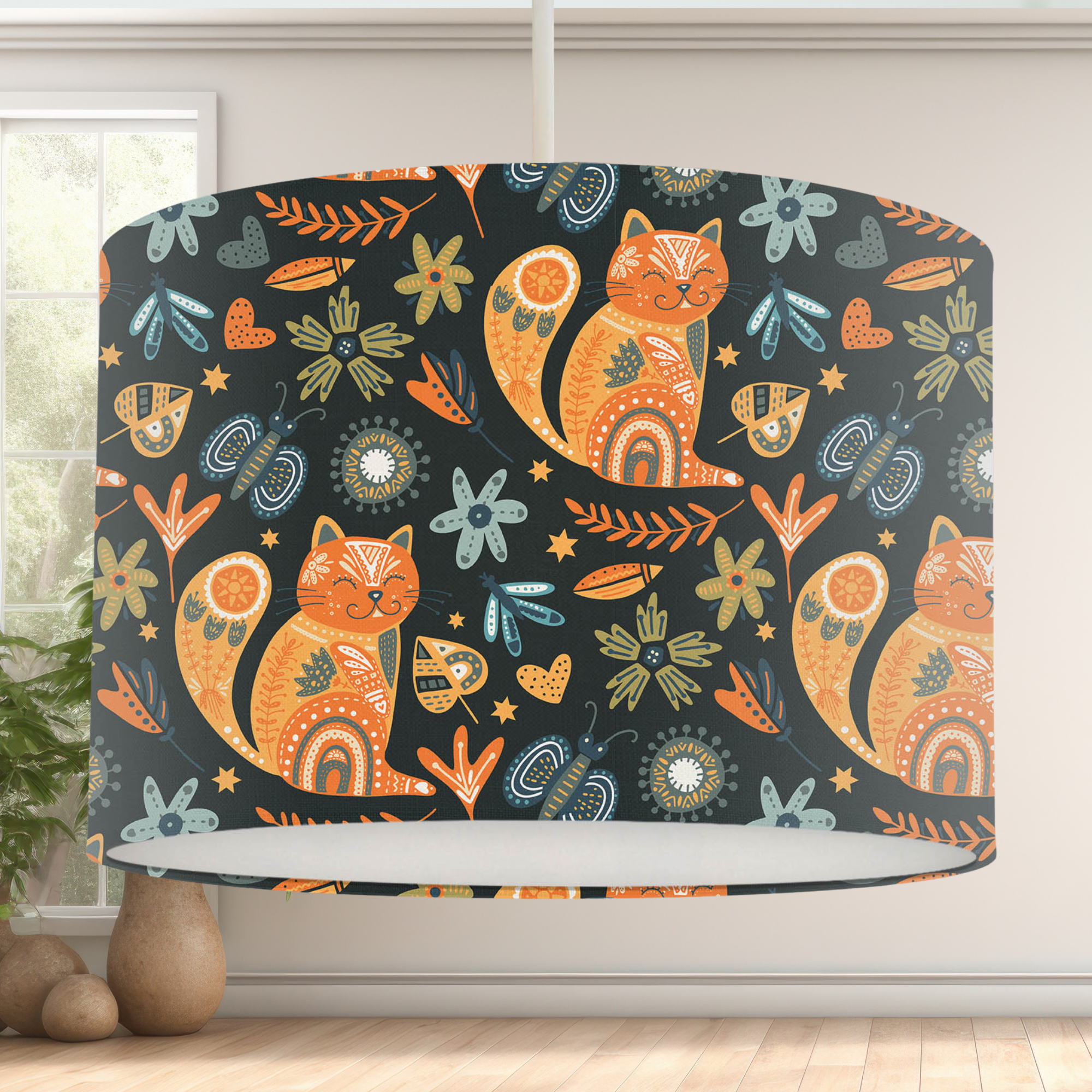 This handmade lampshade features a boho inspired pattern of content little pussy cats among leaves, florals and butterflies in tones of orange, blue and green on a black background.