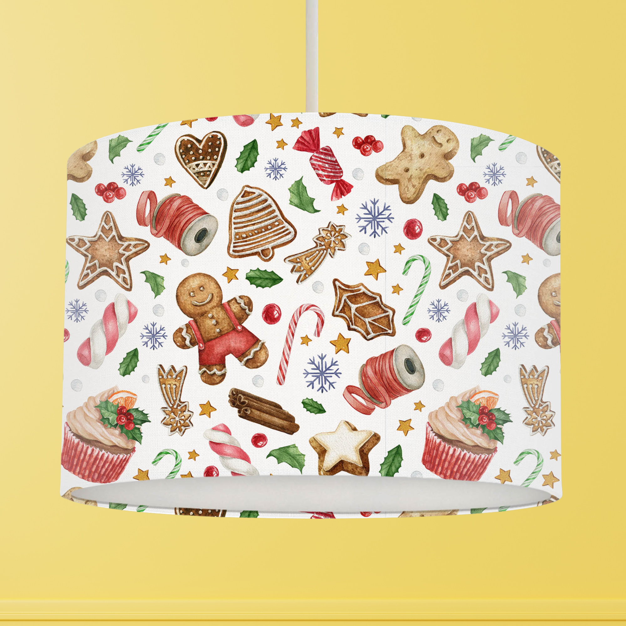 This Christmas themed lampshade features a fun festive pattern of sweets, berries, holly leaves, cupcakes, gingerbread cookies and candy canes on a white background.
