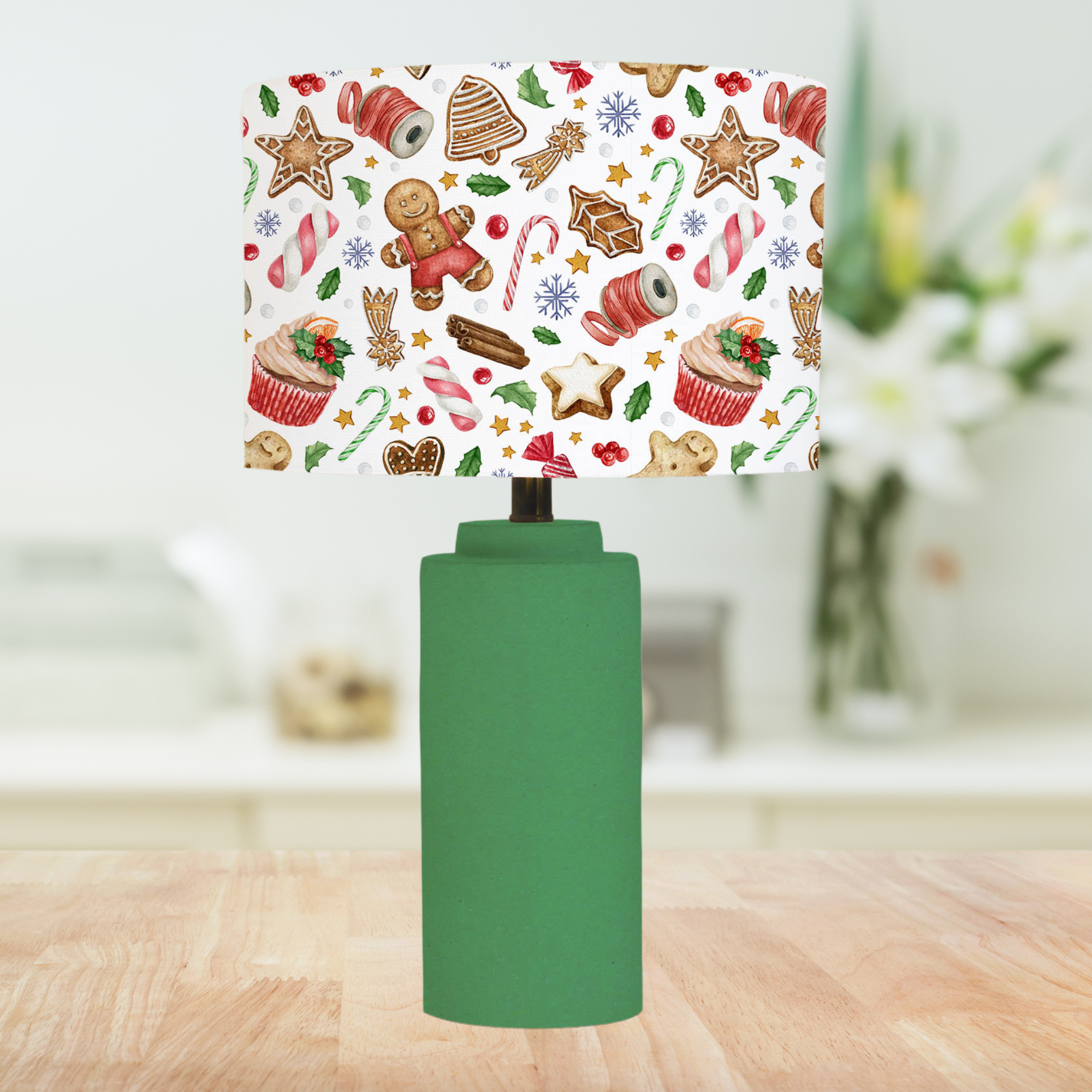This Christmas themed lampshade features a fun festive pattern of sweets, berries, holly leaves, cupcakes, gingerbread cookies and candy canes on a white background.