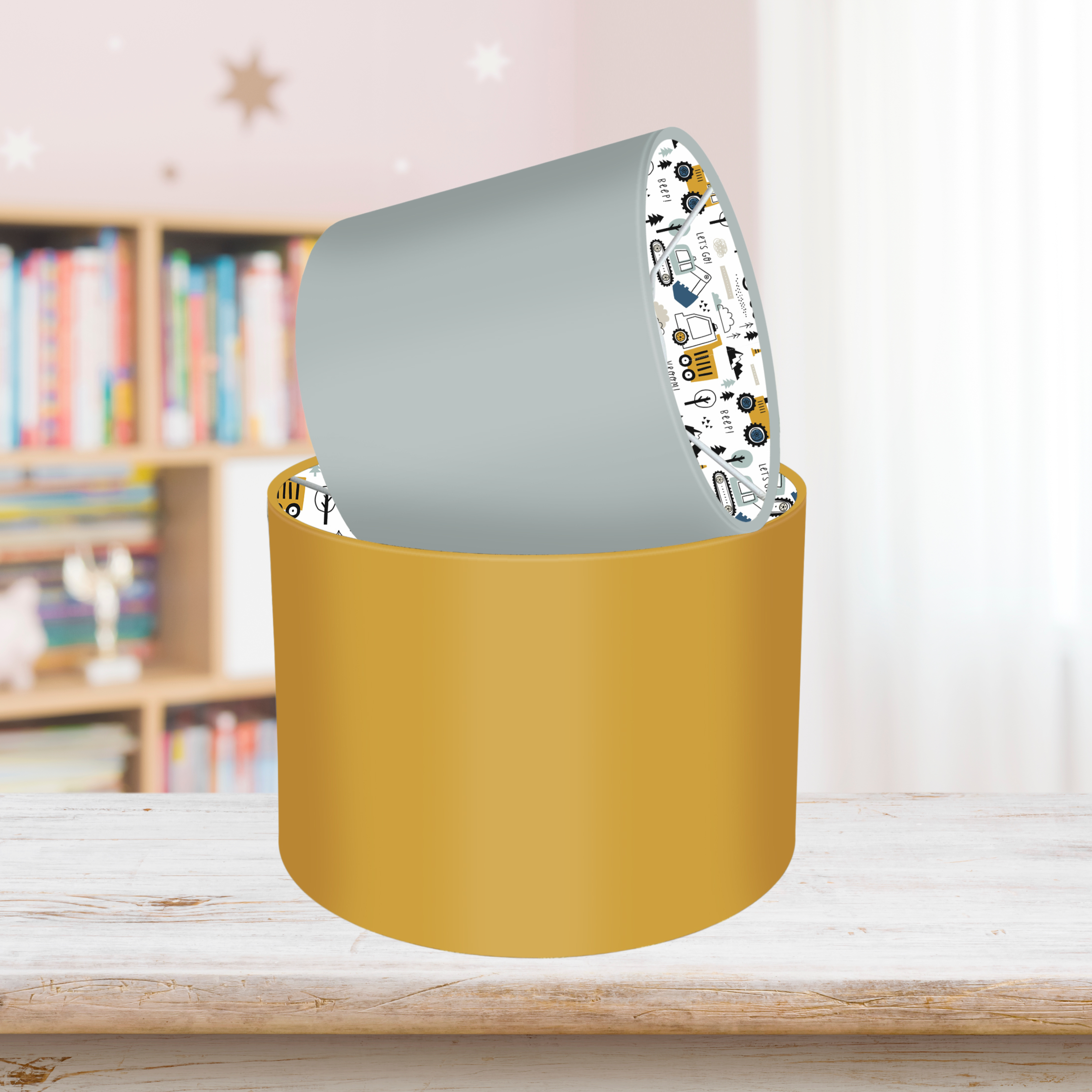 This fun lined ceiling lampshade features our best selling 'Let's Go' pattern featuring construction vehicles including cranes, tractors and diggers on the inside, and your choice of a solid blue, mustard or grey on the outside.
