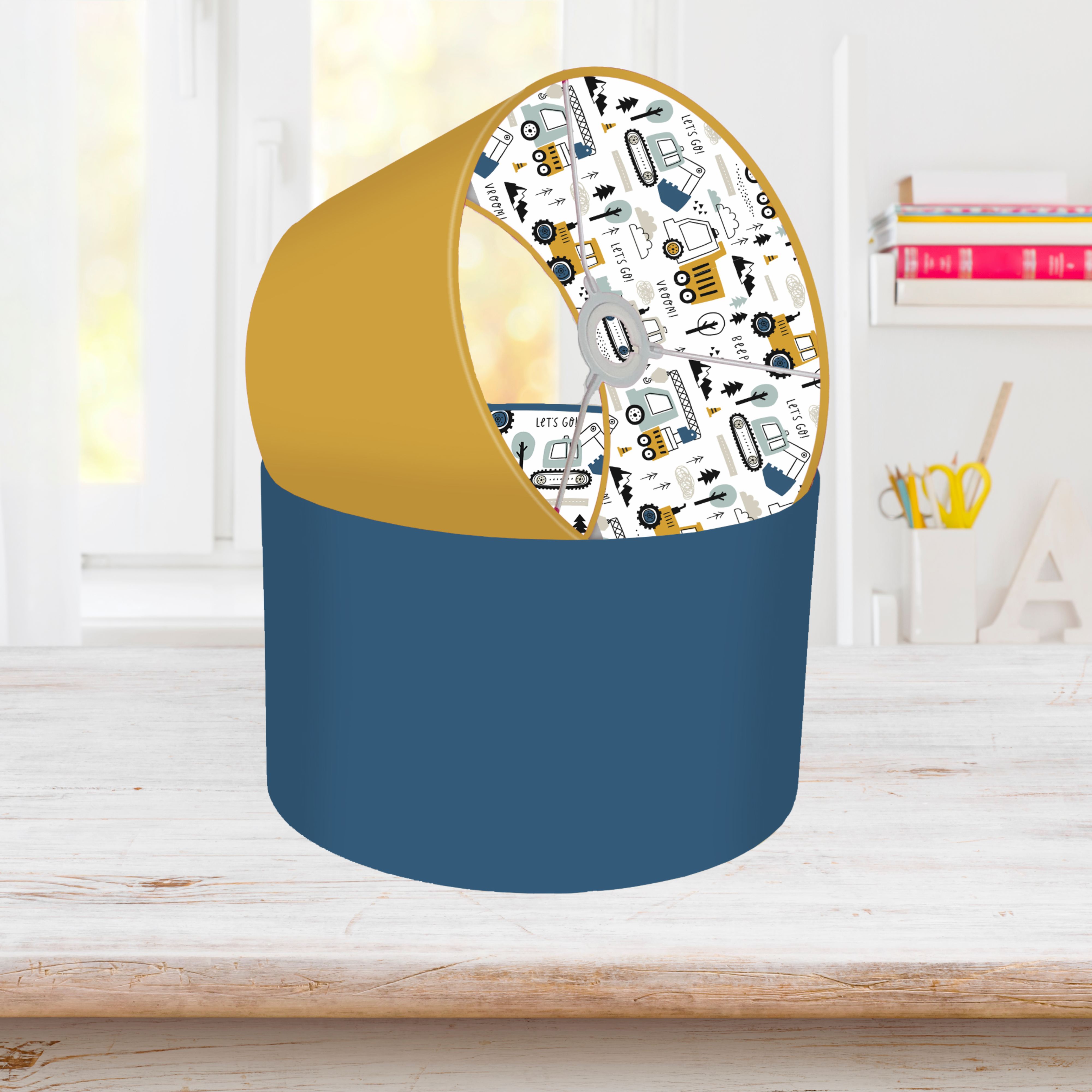 This fun lined ceiling lampshade features our best selling 'Let's Go' pattern featuring construction vehicles including cranes, tractors and diggers on the inside, and your choice of a solid blue, mustard or grey on the outside.