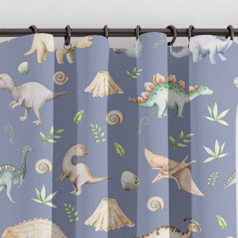 Blackout lined children's bedroom and nursery curtains featuring watercolour dinosaurs on a petrol blue background. Made to measure curtains, custom made to your exact requirements by our professionally trained curtain maker.