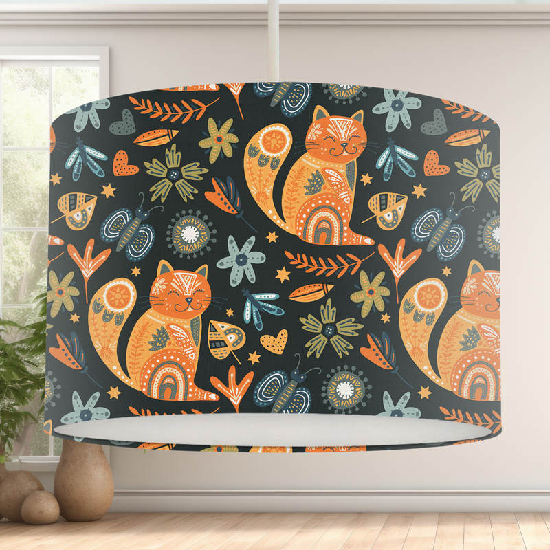 This handmade lampshade features a boho inspired pattern of content little pussy cats among leaves, florals and butterflies in tones of orange, blue and green on a black background.   