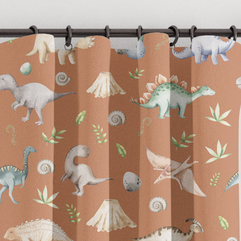 Blackout lined children's bedroom and nursery curtains featuring watercolour dinosaurs on a terracotta background.  Made to measure curtains, custom made to your exact requirements by our professionally trained curtain maker.