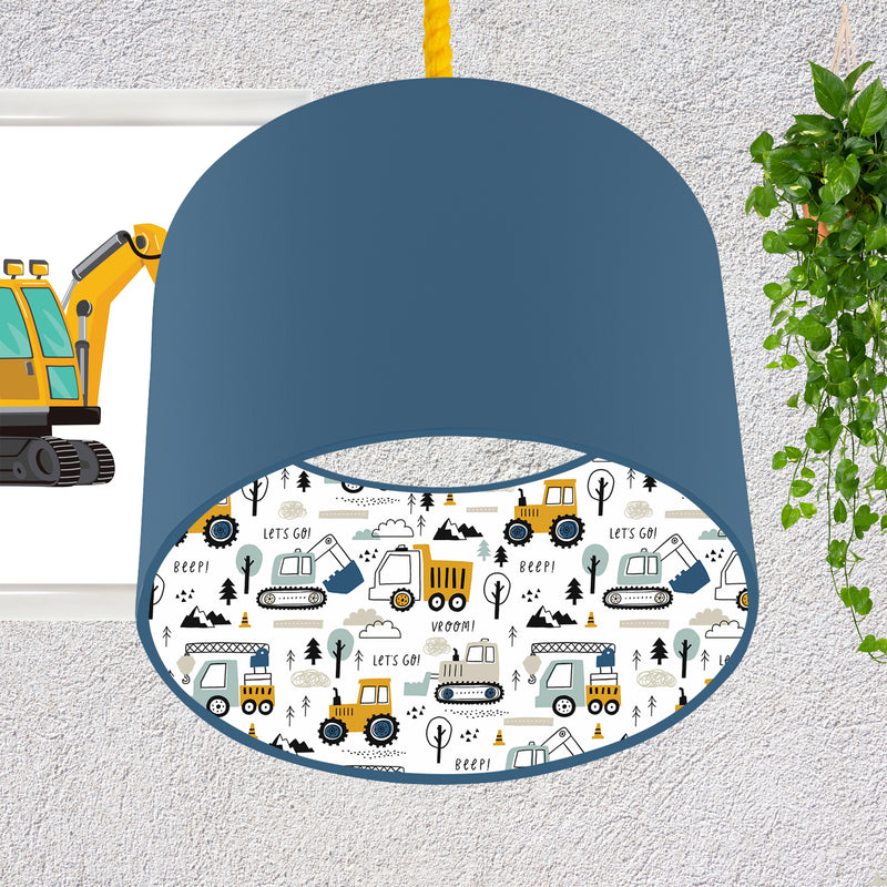 This fun lined ceiling lampshade features our best selling 'Let's Go' pattern featuring construction vehicles including cranes, tractors and diggers on the inside, and your choice of a solid blue, mustard or grey on the outside.  