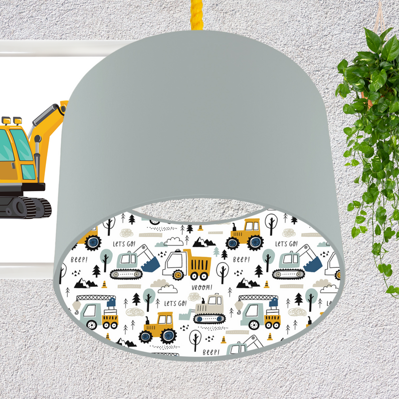 This fun lined ceiling lampshade features our best selling 'Let's Go' pattern featuring construction vehicles including cranes, tractors and diggers on the inside, and your choice of a solid blue, mustard or grey on the outside.  