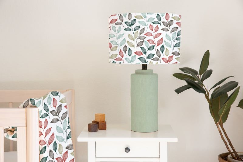 Children's bedroom and nursery ceiling and lampshade, blue, green, red and grey colored autumn leaves.