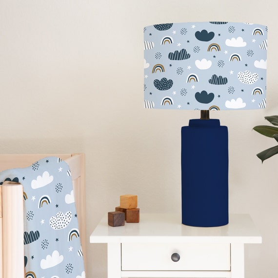 Children's bedroom and nursery lampshade lightshade for ceiling fitting or lamp base featuring rainbows and clouds on a blue background.
