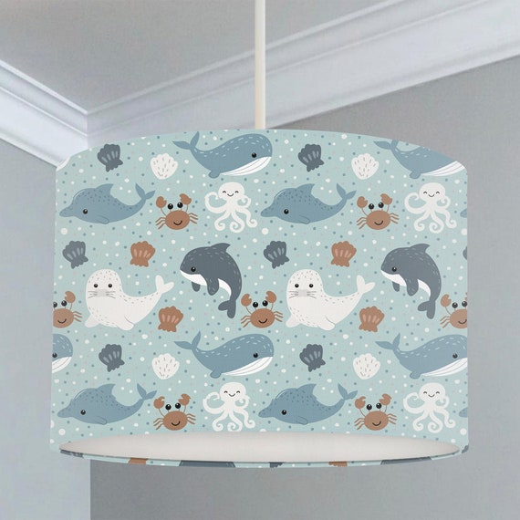 Children's bedroom and nursery ceiling lampshade featuring sweet little sea creatures including whales, crabs, seals and dolphins on a light blue background.