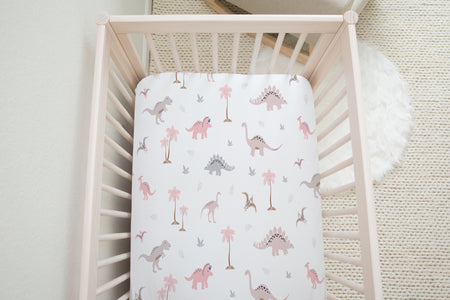 Pink dinosaur fitted cot sheet for children's bedrooms and nurserys