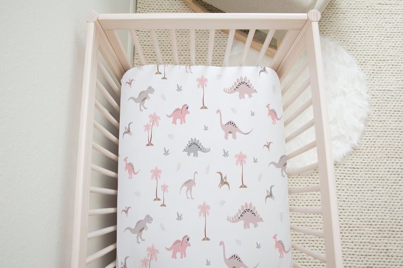 Pink dinosaur fitted cot sheet for children's bedrooms and nurserys
